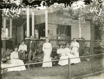 'A group of five ladies and one gentleman at some residence. Probably the Madeira house at the intersection of Beverly Avenue and University Driveway. (Mrs. Madeira standing center)'.