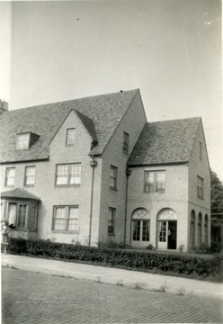 View of the R.M. Davis Home located in Morgantown, W. Va. A girl seen at left near window. 