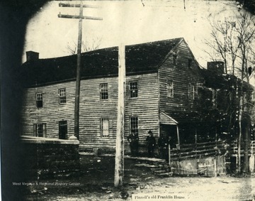 Four men are standing outside Finnell's, the old Franklin House, in Morgantown, West Virginia. 