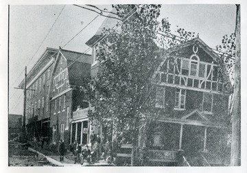 Several men are standing and sitting on the porch of the Maderia Hotel in Morgantown, West Virginia; 'Copied by Bradford Laidley, taken from Prosperity and Education Edition of The New Dominion in Morgantown, Feb. 1903.'