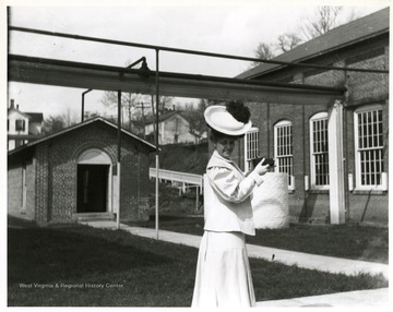 A woman prepares to take a photograph of the Morgantown Power Plant in Morgantown, West Virginia.