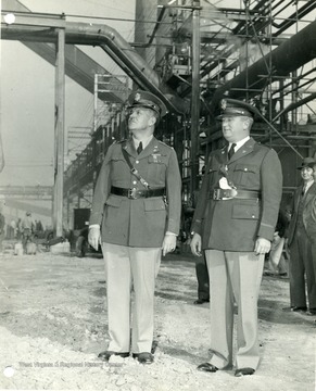 'Colonel Leslie R. Groves, chief of the operations Branch, Washington, D. C. Major Fred O. Mitchell, Deputy zone constructing quartermaster.' Picture taken at Morgantown Ordnance Works in Morgantown, West Virginia. <br /><br /><br /><br />
