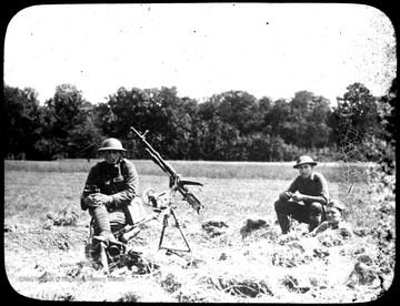 World War I Lantern Slide Show. Slide No. 38 in group of originally numbered slides.  Anti-aircraft gun and three soldiers in a field.  One soldier has binoculars and is smoking a pipe.  Frame is labelled with text saying 'Visual Bureau, University of Pittsburgh.'  (negative no. 38-17029 is inscribed on slide)<br /><br /><br /><br />
