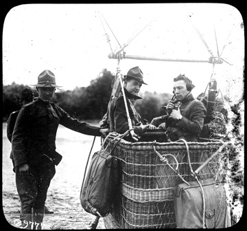 World War I Lantern Slide Show. Slide No. 40 in group of originally numbered slides.  American observation balloon.  Two soldiers are in the balloon's basket, one wearing headphones.  Other soldiers appear to be holding the balloon basket down.  Frame is labelled with text saying 'Visual Bureau, University of Pittsburgh.'  (negative no. 44-9777 is inscribed on slide)<br />
