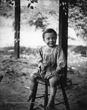 A young boy is sitting on a stool in Morgantown, West Virginia.