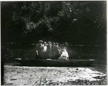 Four women and two men in a boat.