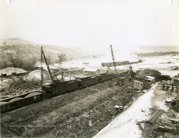 'Morgantown Ordnance Works, Morgantown, W. Va. Photograph Number 102. General View of Coke plant area driving piles for coke oven foundation on left and general grading in center. Taken from photographers platform of West side coke plant looking Southeast. January 30. 1941, 1:30 P.M.'