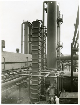 Ammonia Liquor Stills and Condensers, Bldg. 119, center foreground, Light Oil Absorbers, Bldg. 97, left background, Washer Coolers, Bldg. 116, at right.  View looking southeast.  From Volume One of Morgantown Ordnance Plant Pictures at Morgantown, W. Va. Constructed and Operated by the Ammonia Department, E. I. Dupont De Nemours and Company.