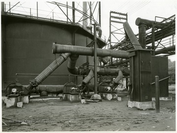 Coke Oven Gas Holder and Boosters, Building 115, View Looking Southwest. From Volume One of Morgantown Ordnance Plant Pictures at Morgantown, W. Va.  Constructed and Operated by the Ammonia Department, E. I. Dupont De Nemours and Company.