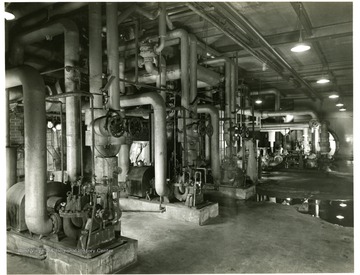Boiler feed pumps and hydraulic pump in foreground.  Building 120, Looking South.  From Volume One of Morgantown Ordnance Plant Pictures at Morgantown, W. Va.  Constructed and Operated by the Ammonia Department, E. I. Dupont De Nemours and Company.