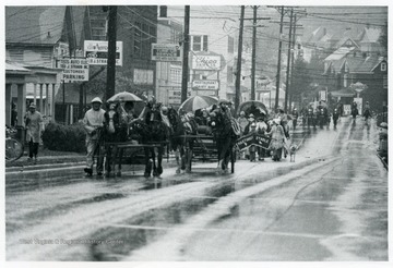 Horse drawn wagons go down Beechurst Avenue.