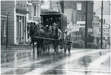 A horse drawn carriage goes down Beechurst Avenue.