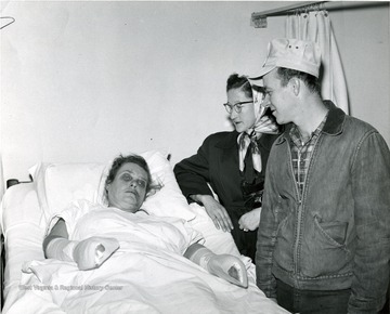Two people visiting a patient with casts on her arms at a the General Hospital in Morgantown, W. Va. 