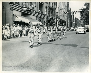 Six members of the Miner's Rescue Squad are marching in a parade in Morgantown, West Virginia.