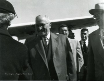 'Truman at Morgantown airport arrival. Governor Marland on his left. Sheriff Clarence E. Johnson at his far left. Tom Jackson between Marland and Johnson.'