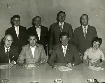 Group of people sitting and standing. 