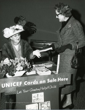 Mrs. Weakley is selling UNICEF cards to an unidentified lady.