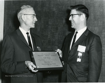 'Immediate Past General Chairman, Roy W. Walter, receiving outstanding service plaque from NSC Staff Representative, Paul T. Stewart.' 'Roy W. Walter (L) Director of Transportation, State Department of Education, Charleston, W. Va.' 