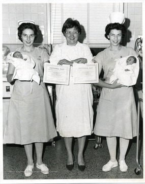 Nurses show the first babies born in 1963, West Virginia's Centennial Year.
