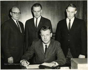 'In the center seated is Mayor Blissett.  On the left is Dr. Kelley, Professor of Agriculture Education.'