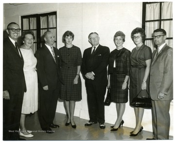 'From left to right: Chester Arents, Dean of Engineering, unknown, Chan Mull, unknown, Charles Stevenson, Superintendant of County Schools, unknown, unknown, Kent Jones, S M Sterling Ford.'