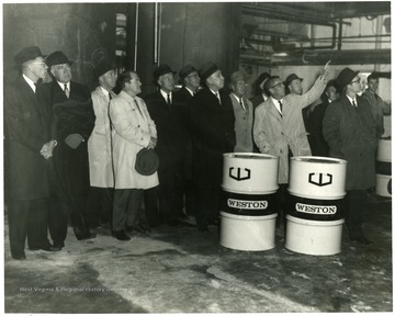 From left to right: Martin Piribek, Dyke Raese, unknown, Samuel K. Haden, unknown, unknown, Mayor Arthur Buehler, J. W. Ruby.  All others unknown.  Barrels labeled Weston.