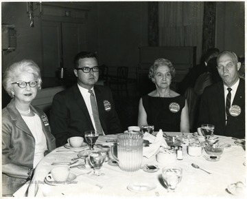 From left to right: Mrs. Simmons who is the owner of Finn's women clothing store and her son Jack Simmons who is also the owner, and an unknown couple.