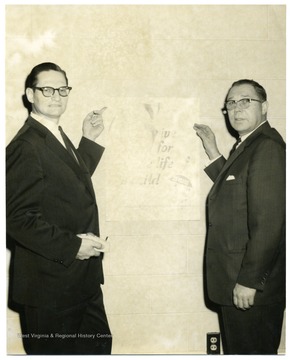 On the left is Donald E. Hayhurst.  Poster is for the Polio Birth Defects and Arthritis Institute.