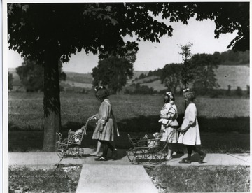 Virginia Rumsey and friends are taking their dolls for a walk.