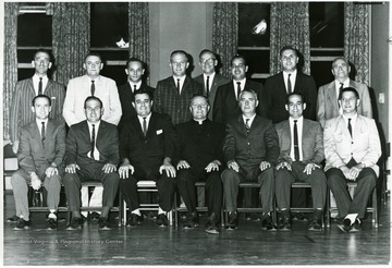 Standing: second from left, Leroy Derigo, fourth from left, Dick Ryan; second from right, Frank DePond.  Seated: third from left, Sam Angotti, fourth from left, Father Nash.