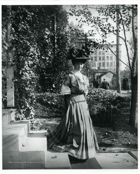 A woman is standing on the steps. Possibly the Swisher Theatre is in the background.