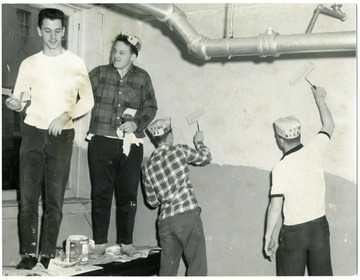 The two men standing on the table are from left to right: Conley Wallace and Mottie Pavone.