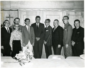 The identified subjects  are, from right to left:  Rev. Stacy Groscup, Jim Hurt, Edward Goe, Danny Kimble, Coach Jim Carlin, others unknown.