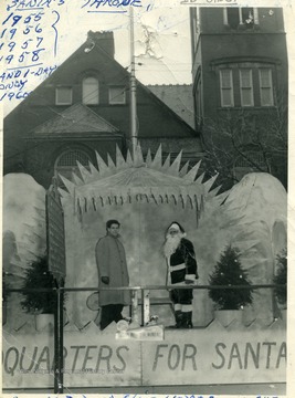 Russel L. Long and his helper standing by 'Santa's Throne' on the courthouse square in Morgantown, W. Va. 