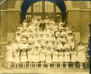 View of children posed outside St. Francis School in Morgantown W. Va. Possibly first communion.