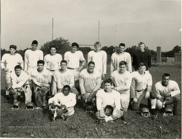 View of St. Francis football team posed on field. Identified in the back row: second from left is Sellaro, then Sam Loretta, David Decarlo, Vaugh Kovack, last two unidentified.   Middle Row, crouching, fourth from right, Mickey Pompelli, far right, Frank Black.