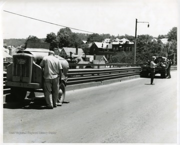 Road crew members are repairing High Street Bridge in Morgantown, West Virginia.