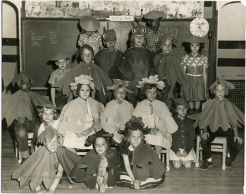 A group portrait of students dressed up in costumes for a school play.