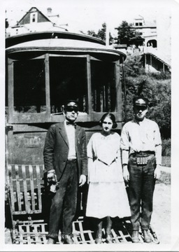 'Summer Car Number 4, West Virginia Traction and Electric Company. Taken at curve, Falling Run Road, July 4, 1919. Left to right: John Sweitzer, Morgantown, Clara E. Mills, Passenger, and Harry F. Mills, conductor.'