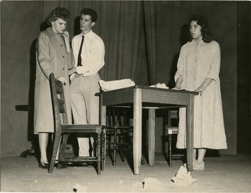 Three high school students in a school play, possibly University High School. 