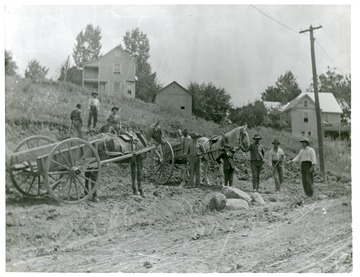 Road crew members and their horses are building a road in Morgantown, West Virginia.