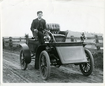 Fourtney Wade is sitting in a Grout steam automobile on Wilson Avenue in Morgantown.The Grout cars were originally sold under the "New Home" name in the 1890s, before rebranding as Grout Brother Automobiles after switching from internal combustion engines to steam powered cars. 1903 was their best sales year.