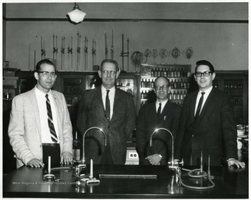 Left to right: Mr. Allamoung (?); Carroll C. Palmer, Chemistry teacher; Mr Hollandsworth; and Mr. Jenkins, Principal in a Chemistry classroom in Morgantown High School in Morgantown, W. Va.
