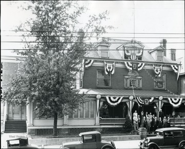 A group of men standing in front of the Elks Lodge on Walnut Street.