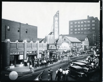 The Grand Opening at Warner Theater in October 1931 on High Street in Morgantown, West Virginia. People are standing in line to watch George Arliss in Millionaire.