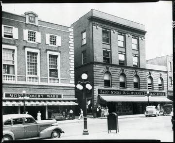 A close-up view of G. C. Murphy Company Store and Montgomery Wards stores on the east side of High Street, Morgantown, West Virginia.