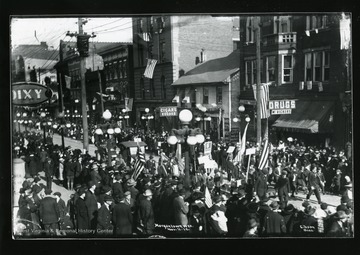 Marchers holding signs in the Armistice Day Parade in Morgantown, West Virginia. 