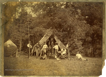 View of assorted men, musical instruments, and guns in a camp setting, Morgantown W. Va.