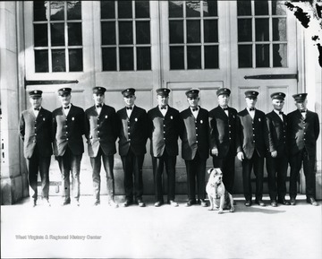 Members of the Morgantown Fire Department, from left to right: "Chief John Hare, John Rich, Mearle Devaughn, Homer Zearley, William Sherman, Rolla Dutton, Plummer Pride, Harry Feck, Dorsey Stalnaker and Friend Barrett. The dog is "Doc," the mascot."Photo appeared in the Morgantown Post on February 23, 1927.