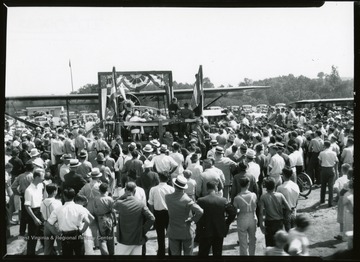 View of Airplane and Speakers' Platform with crowd assembled at Morgantown Airport, W. Va.